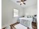 Bright bedroom with wood floors, ceiling fan and large window at 1822 Howard St, Indianapolis, IN 46221