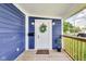 Charming front porch featuring a decorative wreath on the door and stylish outdoor lighting at 1822 Howard St, Indianapolis, IN 46221
