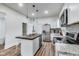 Contemporary kitchen with stainless steel appliances, white cabinetry, and an island with seating at 1822 Howard St, Indianapolis, IN 46221
