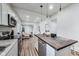 Modern kitchen overlooking the living room featuring white cabinets, stainless steel appliances, and an island at 1822 Howard St, Indianapolis, IN 46221