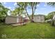 Spacious backyard featuring green grass and two detached garages with neutral siding at 1907 N Drexel Ave, Indianapolis, IN 46218