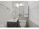 Well-lit bathroom featuring a modern vanity, storage cabinet, and essential fixtures at 1907 N Drexel Ave, Indianapolis, IN 46218