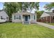 Charming single-story home with blue shutters and a well-manicured front lawn at 1907 N Drexel Ave, Indianapolis, IN 46218