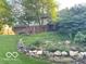 View of expansive backyard, mature trees, and patio at 1941 Spruce Dr, Carmel, IN 46033