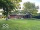 View of expansive backyard, mature trees, and patio at 1941 Spruce Dr, Carmel, IN 46033