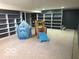 Finished basement with large carpeted area and built in shelves at 1941 Spruce Dr, Carmel, IN 46033
