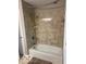 Well-lit bathroom featuring a tub and tiled shower at 1941 Spruce Dr, Carmel, IN 46033