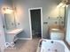 Primary bathroom with a soaking tub, separate vanity, and linen closet at 1941 Spruce Dr, Carmel, IN 46033