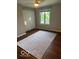 A bedroom with hardwood floors, a ceiling fan, and a sunny window for natural light at 1941 Spruce Dr, Carmel, IN 46033