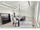Dining room with chandelier, neutral walls, and a view into the adjacent kitchen at 1941 Spruce Dr, Carmel, IN 46033