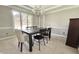 Bright dining room features elegant chandelier, neutral paint, and large window at 1941 Spruce Dr, Carmel, IN 46033