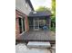Exterior view of a screened-in porch attached to a brick home with a wooden deck at 1941 Spruce Dr, Carmel, IN 46033