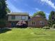 Charming two-story home with blue door and well-manicured lawn at 1941 Spruce Dr, Carmel, IN 46033