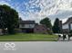 Two-story home with brick and siding exterior plus a well-maintained front lawn at 1941 Spruce Dr, Carmel, IN 46033