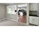 View into the kitchen from an adjacent room showcases white cabinets and an island at 1941 Spruce Dr, Carmel, IN 46033