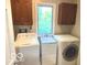Practical laundry room with storage cabinets and a utility sink at 1941 Spruce Dr, Carmel, IN 46033