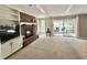 Spacious living room features a brick fireplace and sliding door to a patio at 1941 Spruce Dr, Carmel, IN 46033