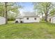 A backyard view of a home with a grill, small patio and an old shed in the background at 2 S 25Th Ave, Beech Grove, IN 46107