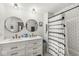 A bathroom with a double sink vanity, subway tile backsplash and shower and patterned shower curtain at 2 S 25Th Ave, Beech Grove, IN 46107