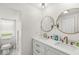 A bathroom with a double sink vanity, marble countertop, tile floors and modern gold faucets at 2 S 25Th Ave, Beech Grove, IN 46107