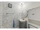 Bathroom with updated vanity, mirror and brick style accent wall at 2 S 25Th Ave, Beech Grove, IN 46107