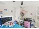 Cozy bedroom features fun décor, bright accents and a ceiling fan at 2 S 25Th Ave, Beech Grove, IN 46107