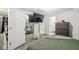 A bedroom with a TV, a chest of drawers, carpet floors and a large bed and mirrored closet doors at 2 S 25Th Ave, Beech Grove, IN 46107