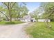 View of the front of the house, with an attached garage and a long gravel driveway at 2 S 25Th Ave, Beech Grove, IN 46107