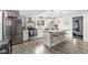 Bright, modern kitchen with stainless steel appliances, a breakfast bar, and wood-look flooring at 2 S 25Th Ave, Beech Grove, IN 46107