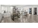 Open floor plan showcasing kitchen with stainless steel appliances, island, and wood-look flooring at 2 S 25Th Ave, Beech Grove, IN 46107