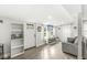 Bright living room with wood-look flooring, large windows, and comfortable seating area at 2 S 25Th Ave, Beech Grove, IN 46107