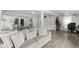 Open-concept living room with a comfortable sofa, wood flooring, and access to the kitchen at 2 S 25Th Ave, Beech Grove, IN 46107