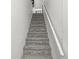Carpeted stairway with a white handrail at 2 S 25Th Ave, Beech Grove, IN 46107