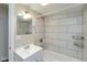 Well-lit bathroom with tiled shower, updated vanity, and modern fixtures at 203 S 17Th Ave, Beech Grove, IN 46107