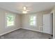 Cozy bedroom features neutral walls, soft carpet, and a ceiling fan for added comfort at 203 S 17Th Ave, Beech Grove, IN 46107