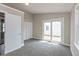 Neutral bedroom boasts carpeting, slider to deck, closets, and neutral tones at 203 S 17Th Ave, Beech Grove, IN 46107