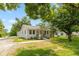 Charming single-story home with a well-manicured lawn and inviting front porch at 203 S 17Th Ave, Beech Grove, IN 46107