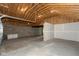 Unfinished garage showing open rafters and concrete floor ready for customizing to your needs at 203 S 17Th Ave, Beech Grove, IN 46107