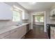 Well-equipped kitchen with stainless steel appliances, white cabinets, and ample counter space at 203 S 17Th Ave, Beech Grove, IN 46107