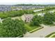 Aerial view of a home surrounded by lush trees, a serene lake, and a well-maintained community at 2070 Mustang Chase Dr, Carmel, IN 46074