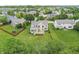 An aerial view displays a pristine backyard with a spacious deck and play set, perfect for outdoor enjoyment and Gathering time at 2070 Mustang Chase Dr, Carmel, IN 46074