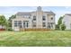 Large backyard with a well-maintained lawn, a spacious deck, and mature trees at 2070 Mustang Chase Dr, Carmel, IN 46074