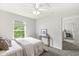 Inviting bedroom with plush carpeting, a ceiling fan, and a view to the ensuite bathroom at 2070 Mustang Chase Dr, Carmel, IN 46074