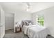 Cozy bedroom features a neutral color scheme, plush carpeting, and a bright window at 2070 Mustang Chase Dr, Carmel, IN 46074