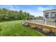 Wooden deck surrounded by greenery and a white metal fence, perfect for outdoor relaxation at 2070 Mustang Chase Dr, Carmel, IN 46074