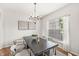 Elegant dining room featuring a modern chandelier, stylish table setting, and views of the outdoors at 2070 Mustang Chase Dr, Carmel, IN 46074