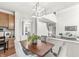 Bright dining room with stylish light fixture and easy access to kitchen and living area at 2070 Mustang Chase Dr, Carmel, IN 46074