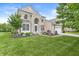 Attractive home with a blend of brick and siding, complemented by a lush green lawn and mature trees at 2070 Mustang Chase Dr, Carmel, IN 46074