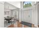 Bright foyer featuring hardwood floors, dining area, and ample natural light streaming through large windows at 2070 Mustang Chase Dr, Carmel, IN 46074