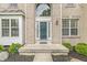 Close-up of the front entrance, showcasing the decorative door, sidelights, and manicured landscaping at 2070 Mustang Chase Dr, Carmel, IN 46074
